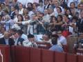 Spectators at a bullfighting event in Andalusia, Spain, showing engagement and excitement.