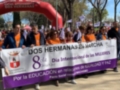 Marcha por el Día Internacional de las Mujeres en Dos Hermanas, con pancartas que destacan la igualdad y la paz.
