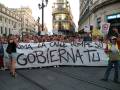 Gente en una manifestación con un cartel que dice "Rompe la calle, rompe su gobierno".