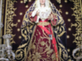Imagen de la Virgen María vestida con vestimentas tradicionales y coronada, posiblemente en un evento religioso o festivo.