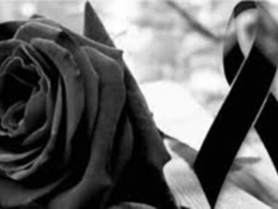 Una rosa negra con un lazo negro, simbolizando tristeza o luto.