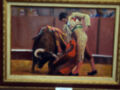 ÓRGANOS: Un cuadro de pintura que muestra a un torero enfrentando a un toro en una plaza de toros. El cuadro está firmemente colgado en una pared con un marco dorado.